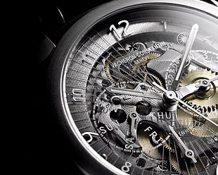 round silver and black Vacheron Constantin skeleton watch